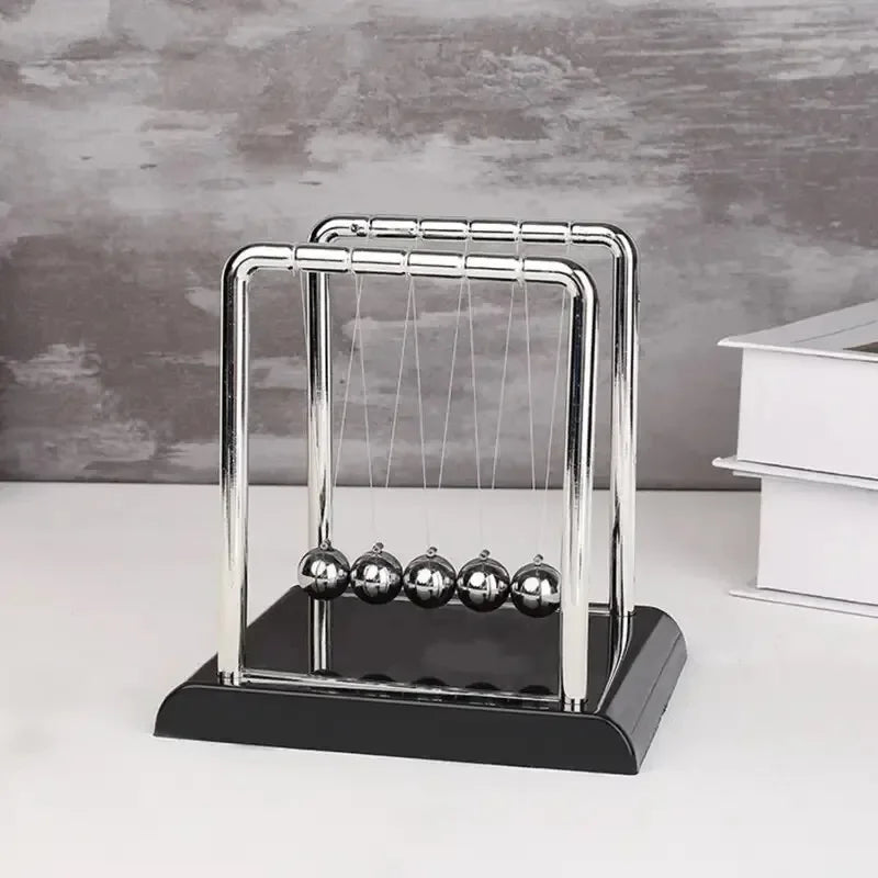 Newton’s Cradle Balance Ball – Steel Physics Pendulum Model for Desk Display. Ideal as a teaching tool, science demonstration, or stress-relief toy. A sleek and modern desktop decoration that combines education, motion, a